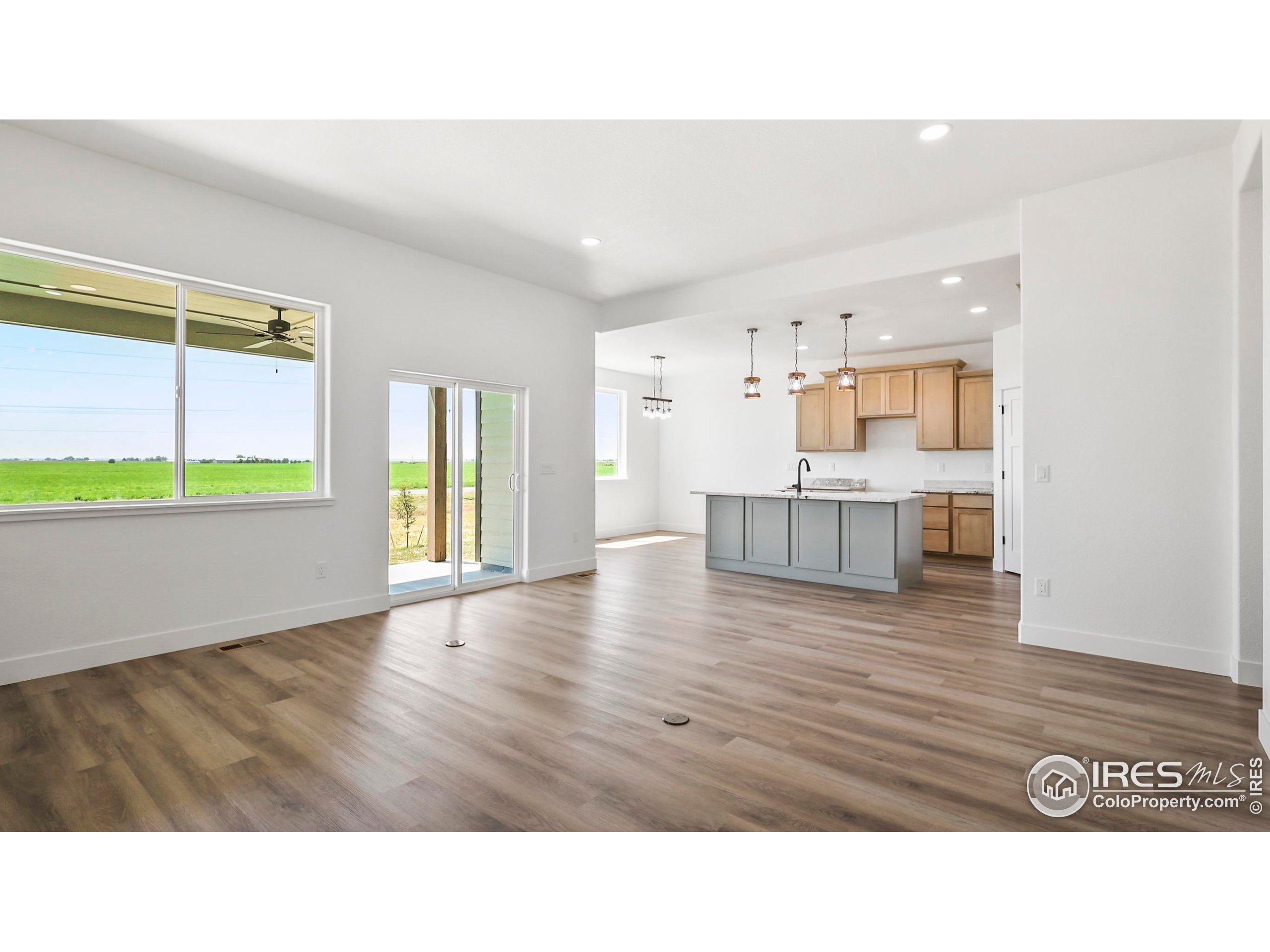 448 Cache Avenue Fort Morgan, CO 80701 - Photo 8 of 44 a living room with kitchen island furniture and a wooden floor