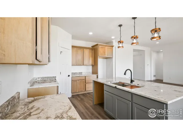 a kitchen with a sink a stove and cabinets