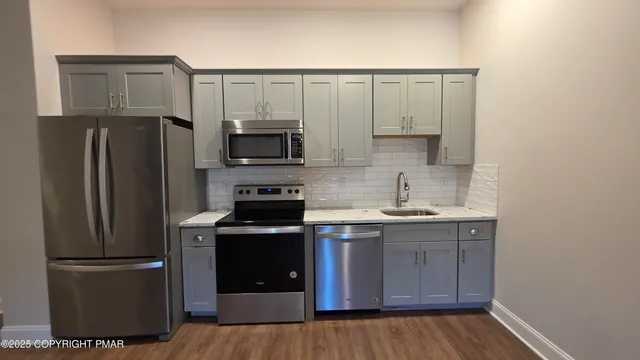 a kitchen with a refrigerator sink and microwave