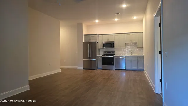 a kitchen with stainless steel appliances a refrigerator and a stove
