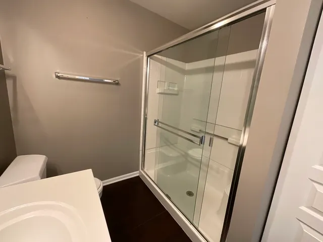 a bathroom with a glass shower door