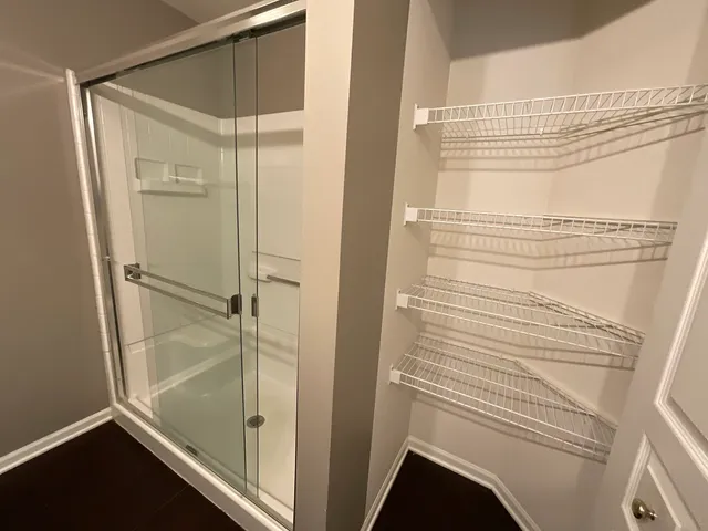 a bathroom with a shower and a sink