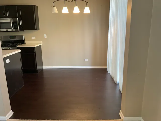 a view of a kitchen with wooden floor and a sink