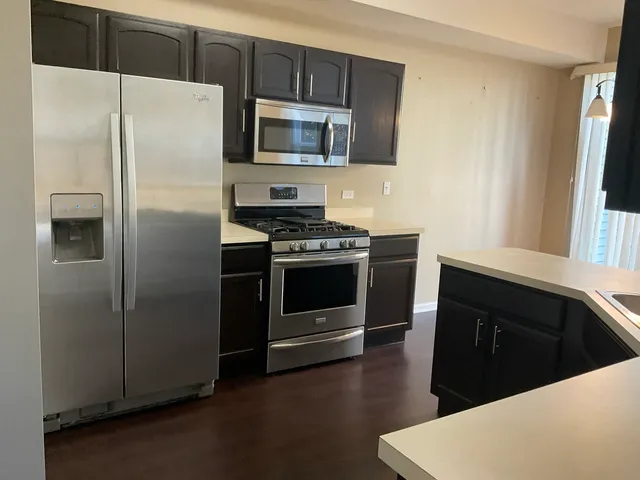 a kitchen with a refrigerator stove and microwave