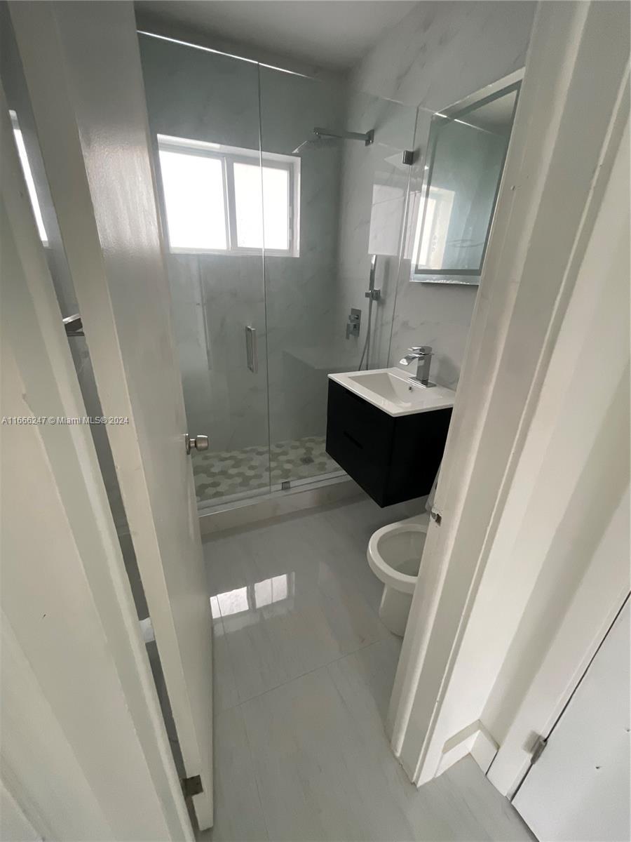 3112 Southwest 16th Street, Unit 3110 Miami, FL 33145 - Photo 11 of 19 a bathroom with a sink toilet and shower