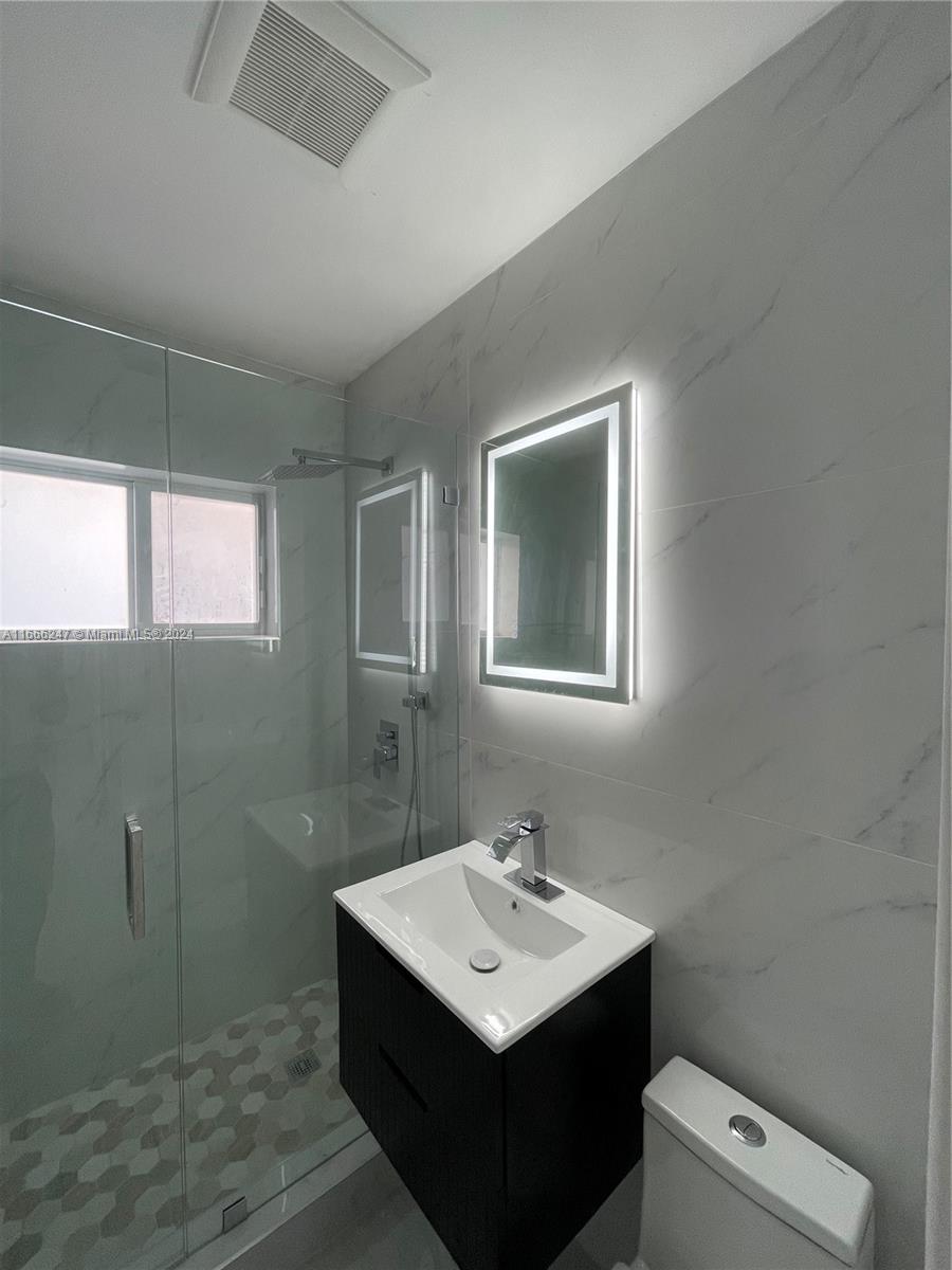3112 Southwest 16th Street, Unit 3110 Miami, FL 33145 - Photo 13 of 19 a bathroom with a sink toilet and mirror