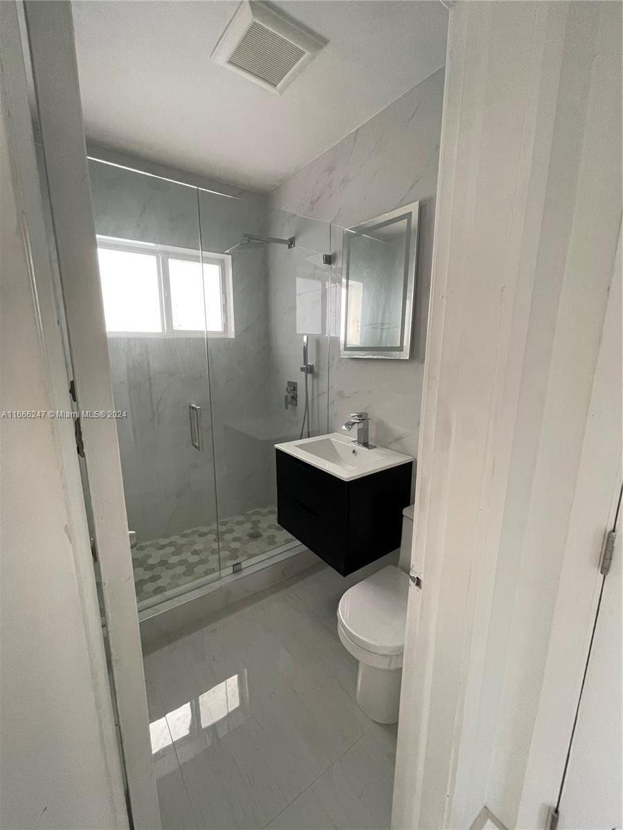 3112 Southwest 16th Street, Unit 3110 Miami, FL 33145 - Photo 14 of 19 a bathroom with a sink toilet and shower
