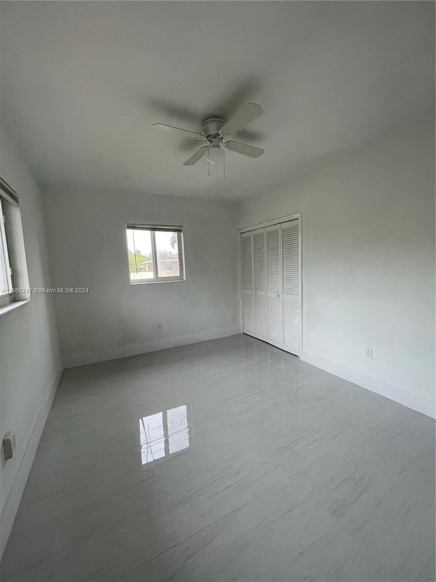 3112 Southwest 16th Street, Unit 3110 Miami, FL 33145 - Photo 16 of 19 an empty room with a window and a ceiling fan