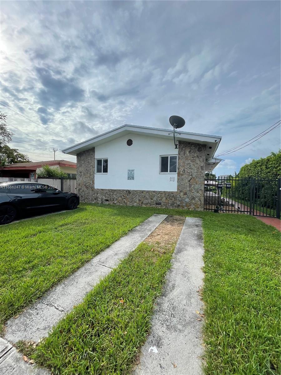 3112 Southwest 16th Street, Unit 3110 Miami, FL 33145 - Photo 2 of 19 a front view of a house with a garden and yard
