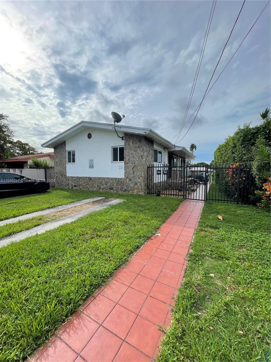 3112 Southwest 16th Street, Unit 3110 Miami, FL 33145 - Photo 3 of 19 a view of a yard in front of house
