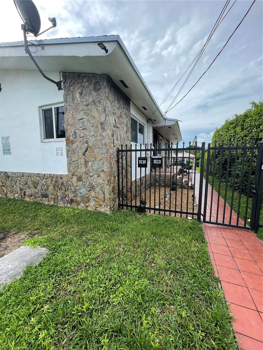 3112 Southwest 16th Street, Unit 3110 Miami, FL 33145 - Photo 4 of 19 a view of a porch with a yard