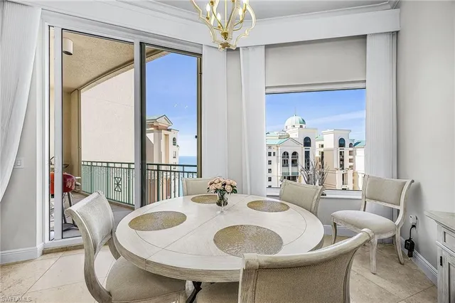 a dining room with furniture a livingroom and chandelier