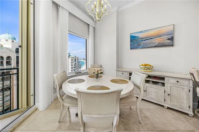 a dining room with furniture and a window