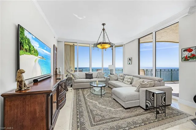 a living room with furniture a window and a flat screen tv