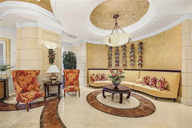 a living room with furniture and a chandelier