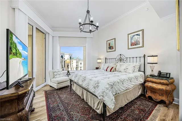 a bedroom with bed and flat screen tv