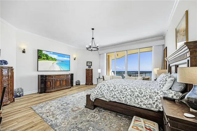 a bedroom with a bed dresser and a flat screen tv