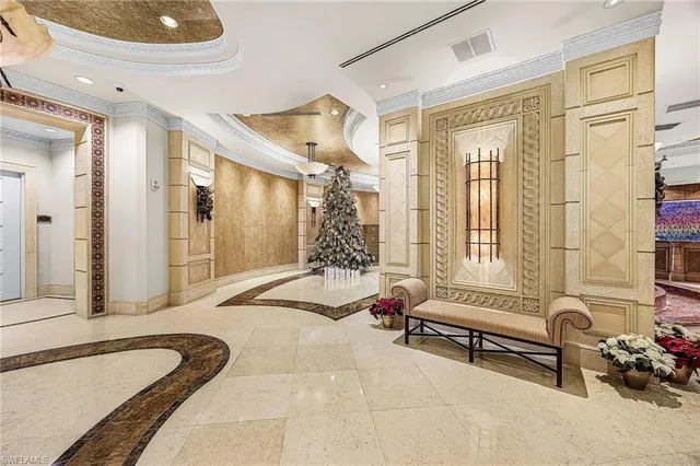 a spacious bedroom with a bed and a chandelier