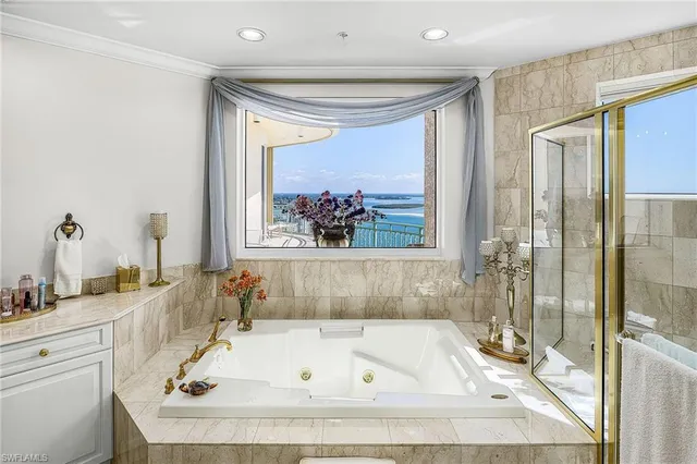 a bathroom with a tub and a window