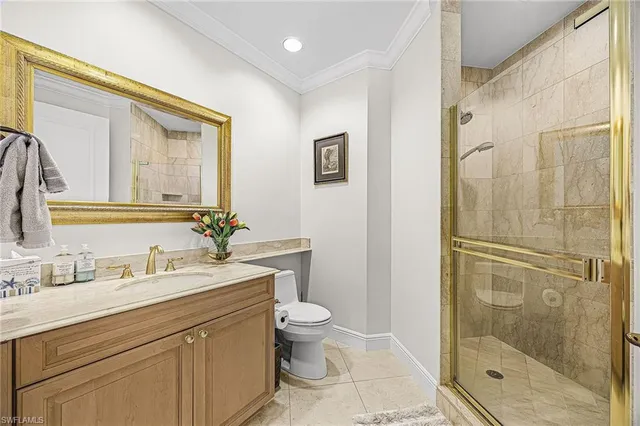 a bathroom with a shower sink vanity mirror and toilet