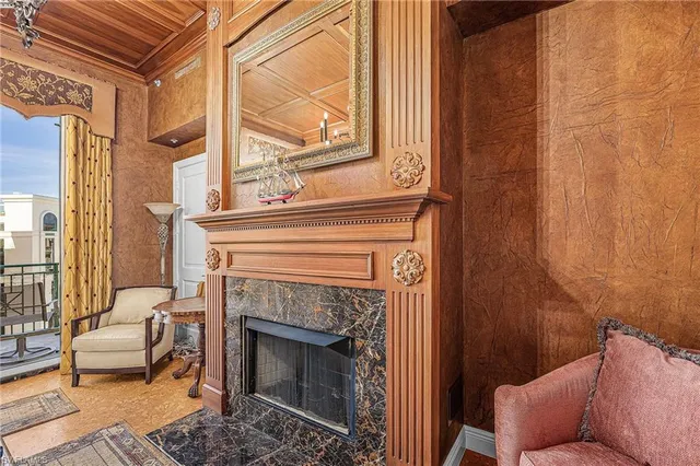 a living room with furniture a window and a fireplace