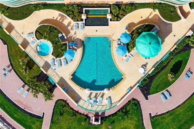 an aerial view of a house with a swimming pool and outdoor seating