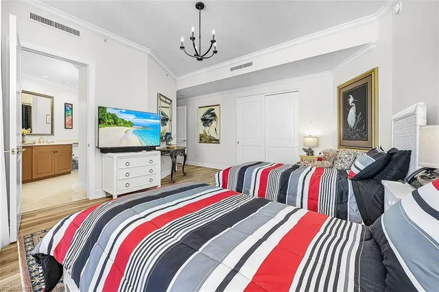 a bedroom with bed and a flat screen tv