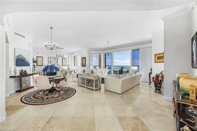 a living room with furniture and a dining table