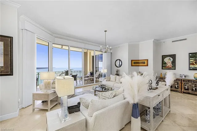 a living room with lots of furniture and view of kitchen