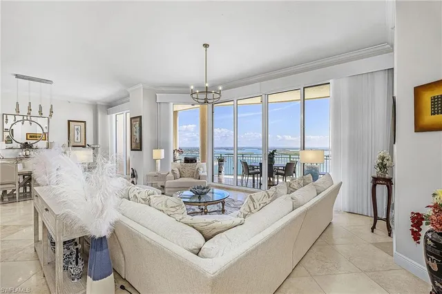 a living room with furniture and a chandelier