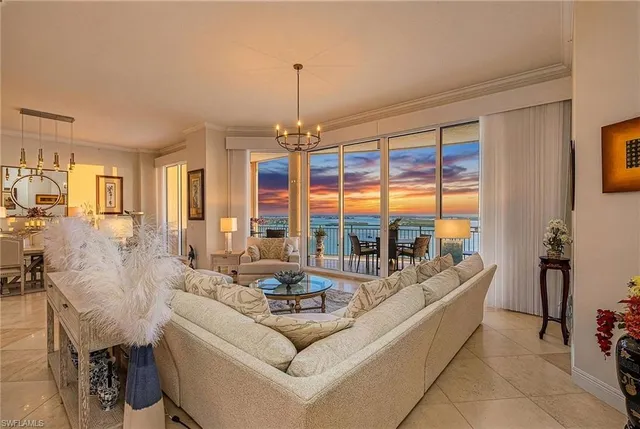 a living room with furniture and a chandelier