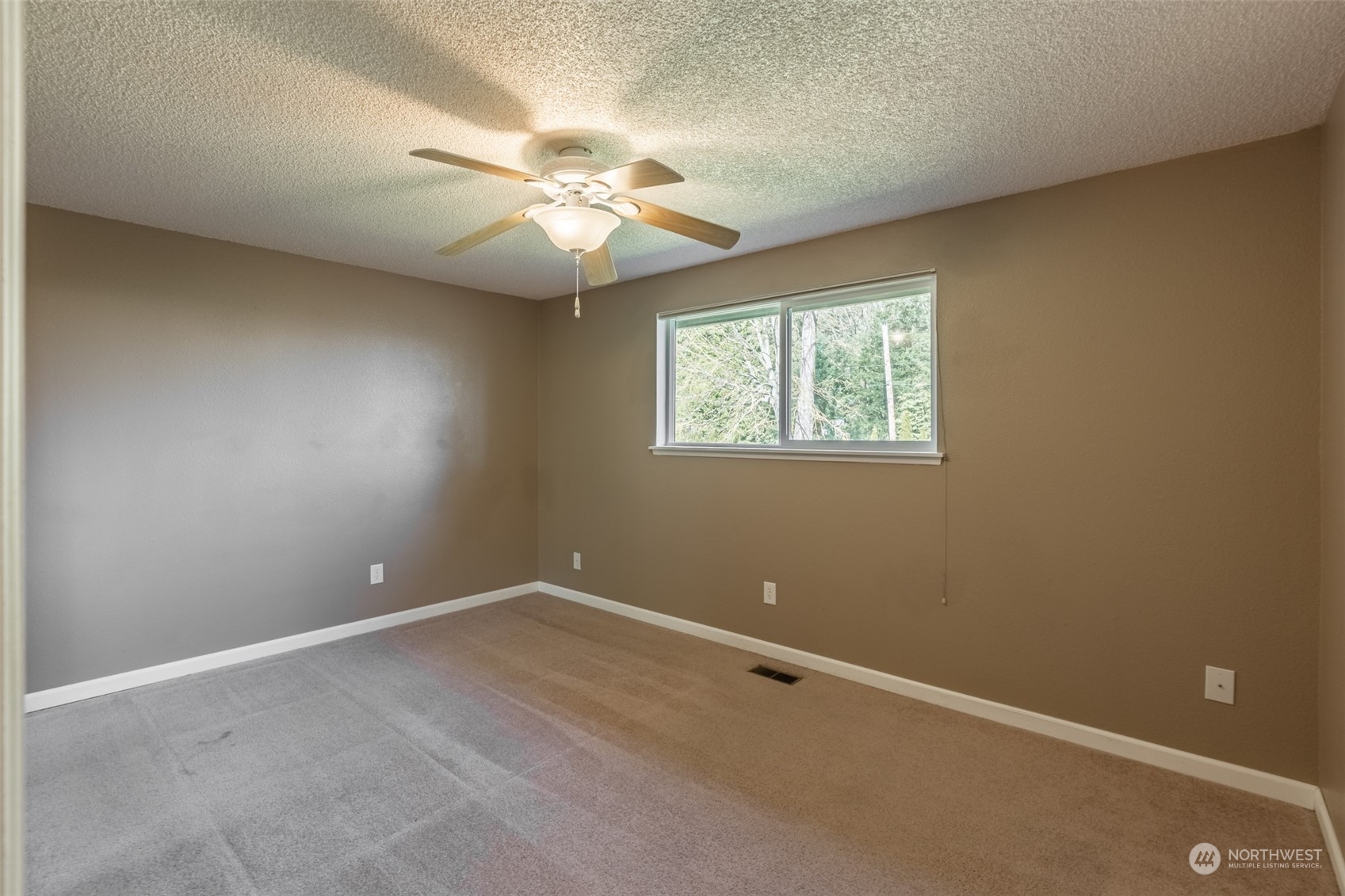 1004 Shaw Road Ferndale, WA 98248 - Photo 11 of 36 an empty room with windows and fan