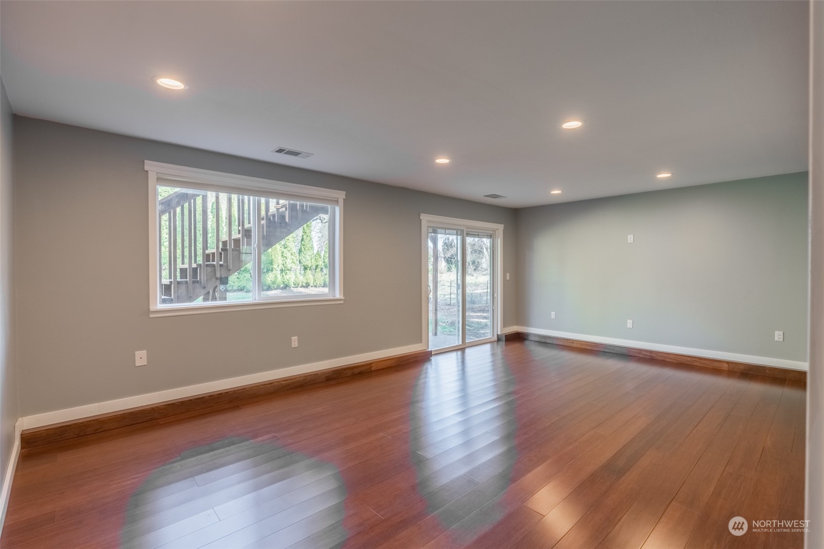 1004 Shaw Road Ferndale, WA 98248 - Photo 21 of 36 a view of an empty room with wooden floor and a window