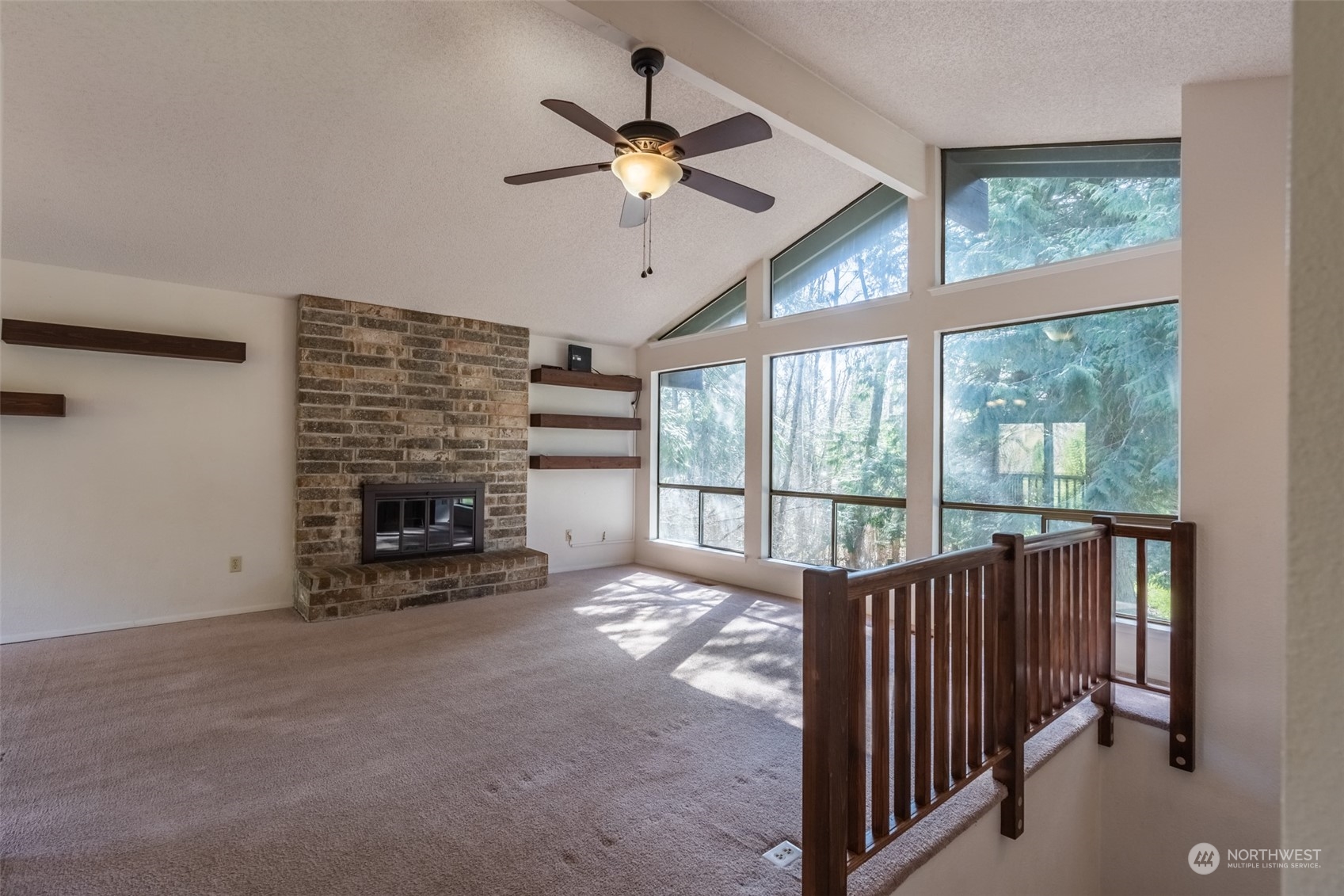 1004 Shaw Road Ferndale, WA 98248 - Photo 3 of 36 a view of a livingroom with a fireplace and a ceiling fan