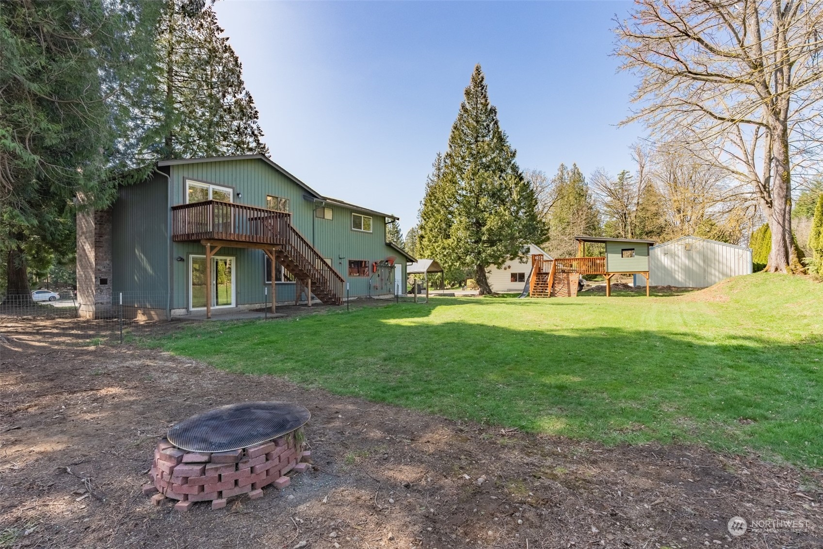 1004 Shaw Road Ferndale, WA 98248 - Photo 31 of 36 a view of a house with backyard and trees