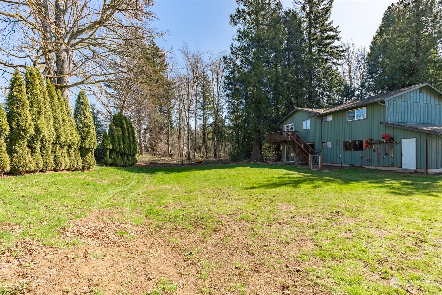 1004 Shaw Road Ferndale, WA 98248 - Photo 34 of 36 a view of a house with a yard and tree