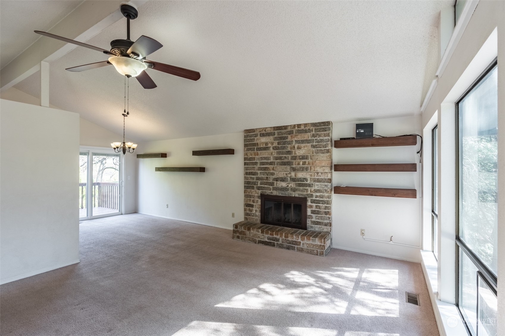 1004 Shaw Road Ferndale, WA 98248 - Photo 4 of 36 a view of a livingroom with a ceiling fan a fireplace and window