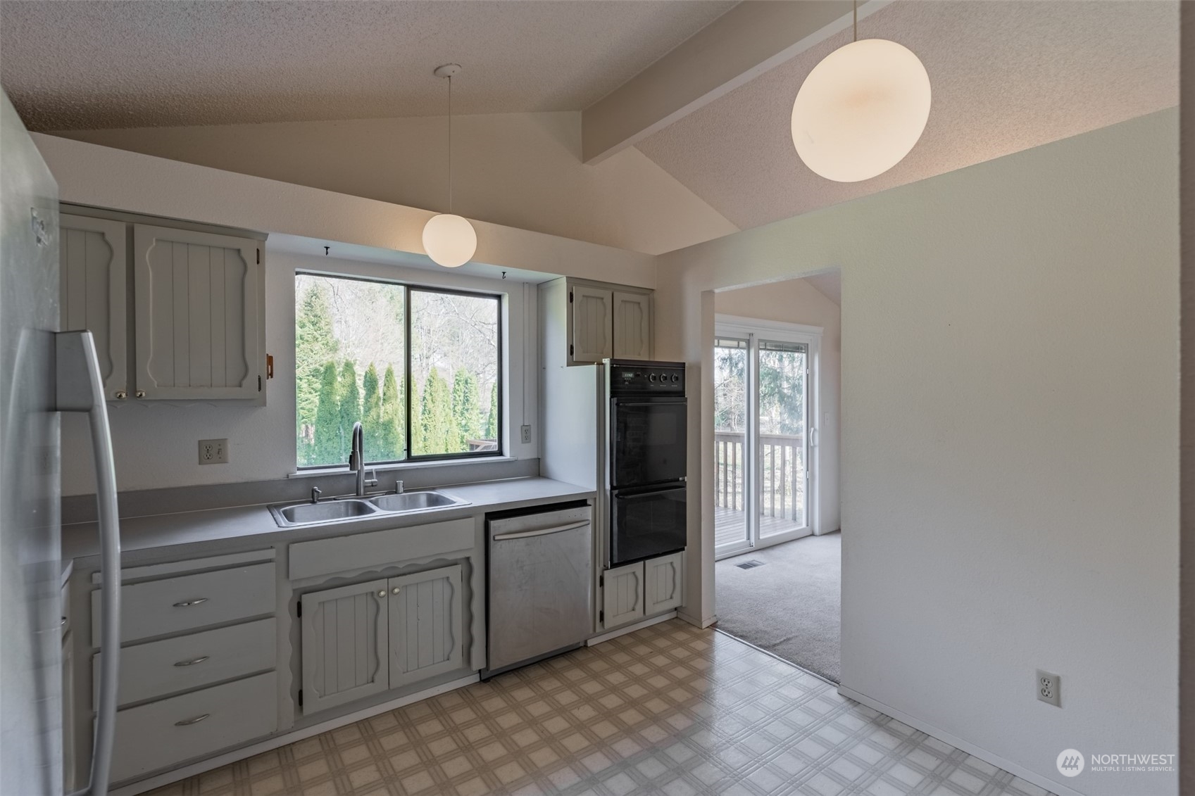 1004 Shaw Road Ferndale, WA 98248 - Photo 8 of 36 a kitchen with stainless steel appliances a sink cabinets and a window