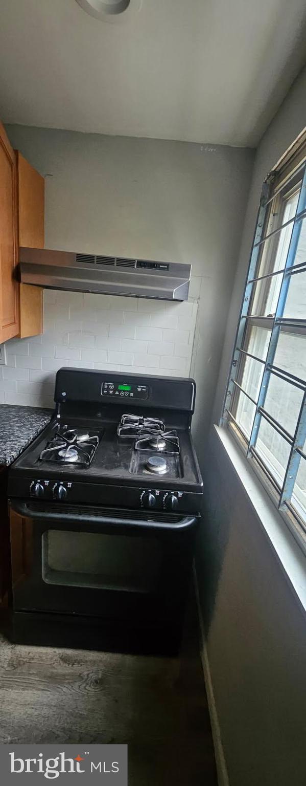 1902 Brunner Street Philadelphia, PA 19140 - Photo 2 of 11 a stove top oven sitting inside of a kitchen