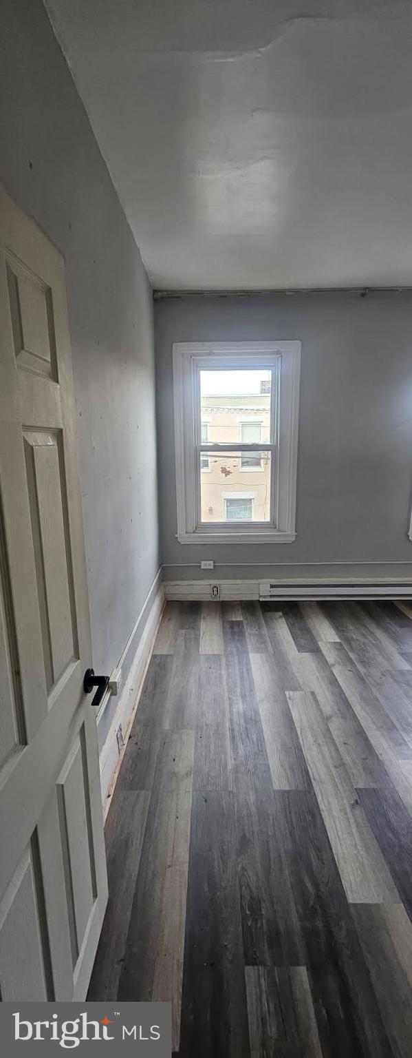 1902 Brunner Street Philadelphia, PA 19140 - Photo 5 of 11 an empty room with wooden floor and windows