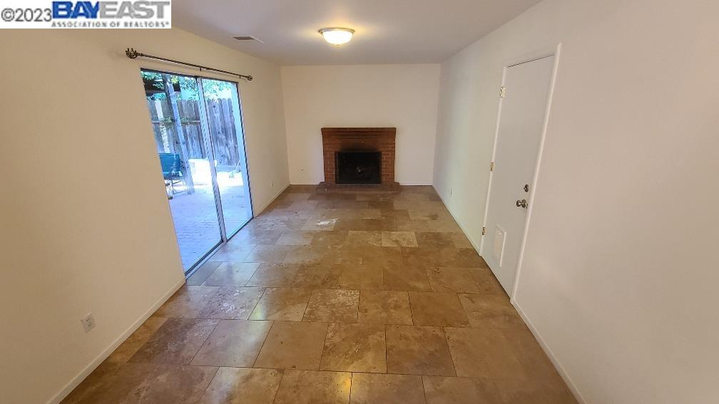 1501 L Street Davis, CA 95616 - Photo 11 of 23 a view of a hallway to an empty room with wooden floor and a window