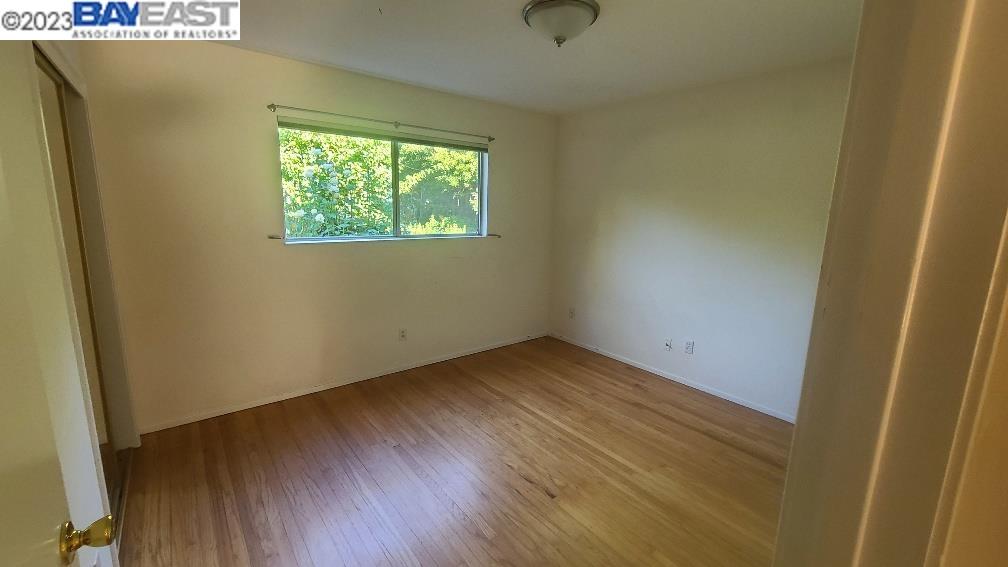 1501 L Street Davis, CA 95616 - Photo 15 of 23 an empty room with wooden floor and windows