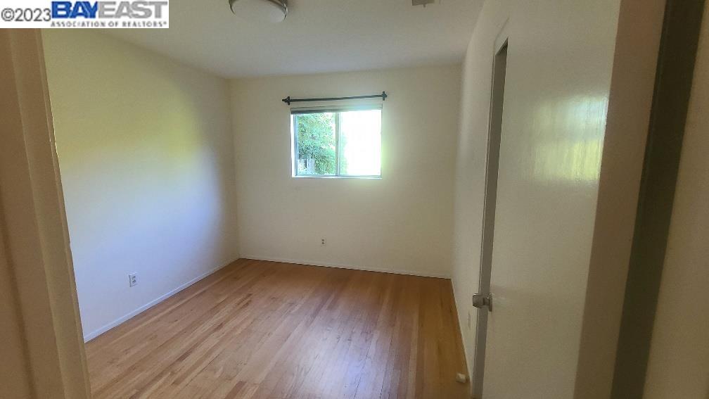 1501 L Street Davis, CA 95616 - Photo 19 of 23 an empty room with wooden floor and windows