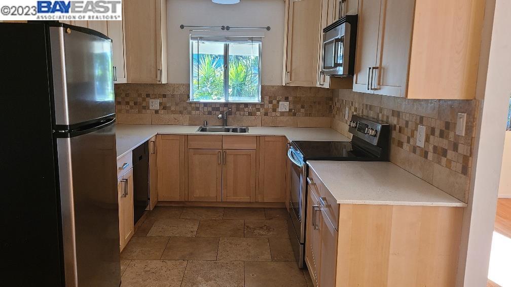 1501 L Street Davis, CA 95616 - Photo 8 of 23 a kitchen with a sink and a refrigerator