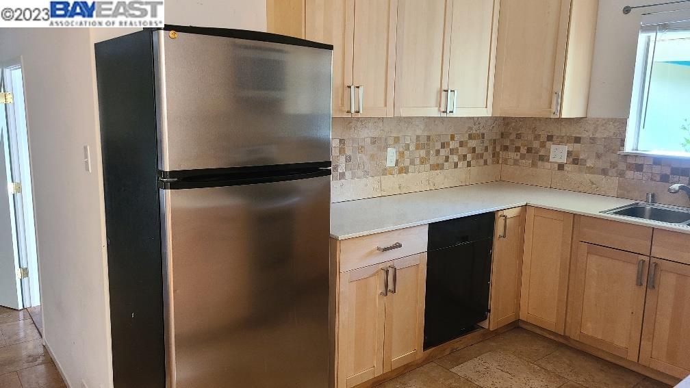 1501 L Street Davis, CA 95616 - Photo 9 of 23 a kitchen with metallic refrigerator freezer and a dishwasher
