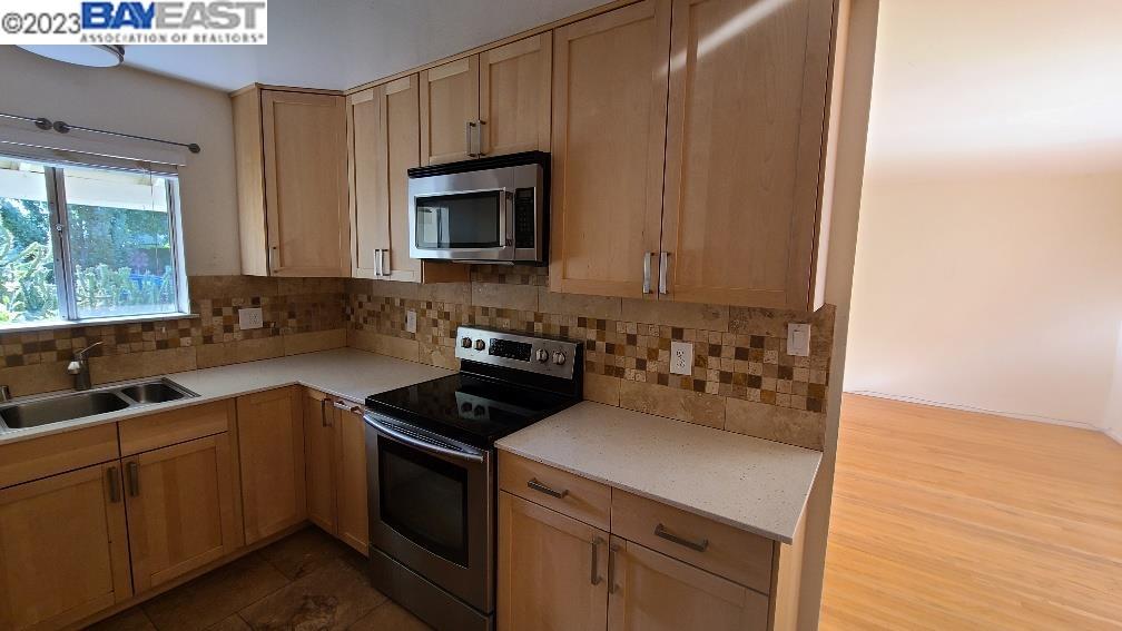 1501 L Street Davis, CA 95616 - Photo 10 of 23 a kitchen with a sink stove and microwave