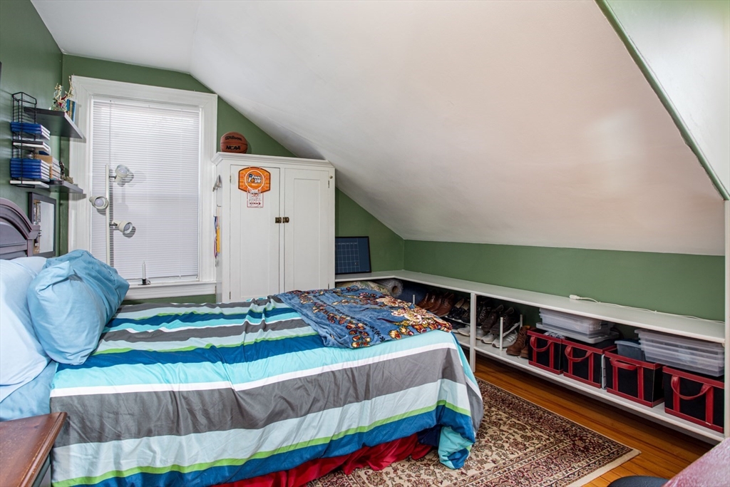 1231 Robeson Street Fall River, MA 02720 - Photo 25 of 39 a bedroom with a bed and a wooden floor