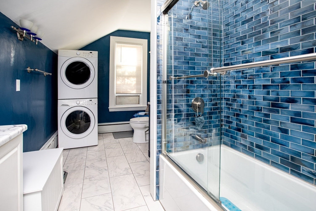 1231 Robeson Street Fall River, MA 02720 - Photo 35 of 39 a bathroom with a tub a sink and a washing machine