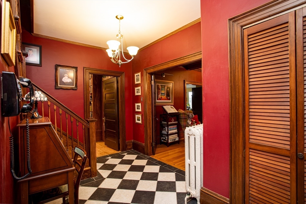 1231 Robeson Street Fall River, MA 02720 - Photo 7 of 39 a hallway with a dining table and a chandelier