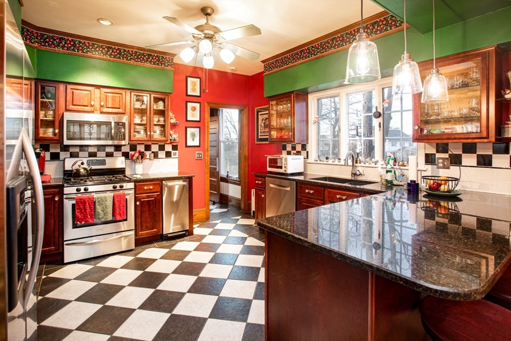 1231 Robeson Street Fall River, MA 02720 - Photo 8 of 39 a kitchen with stainless steel appliances granite countertop a stove a sink and a refrigerator